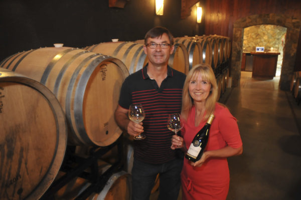 John and Debbie Woodward in the barrell room at their winery in Westsyde. MURRAY MITCHELL/THE DAILY NEWS with jason story and other pics 16AUG13-WINERY2