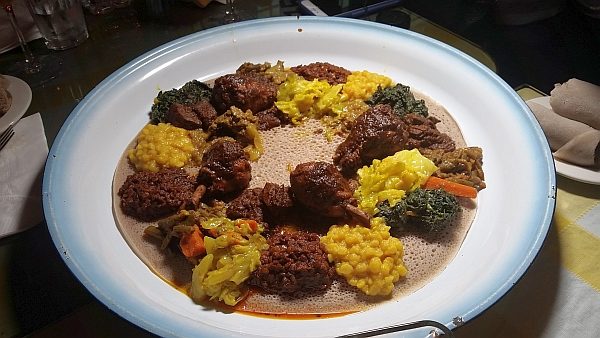 A Traditional Ethiopian platter with vegetables, legumes and chicken to eat by hand. 